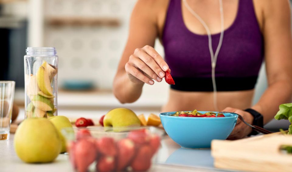 woman eating fruit bowl